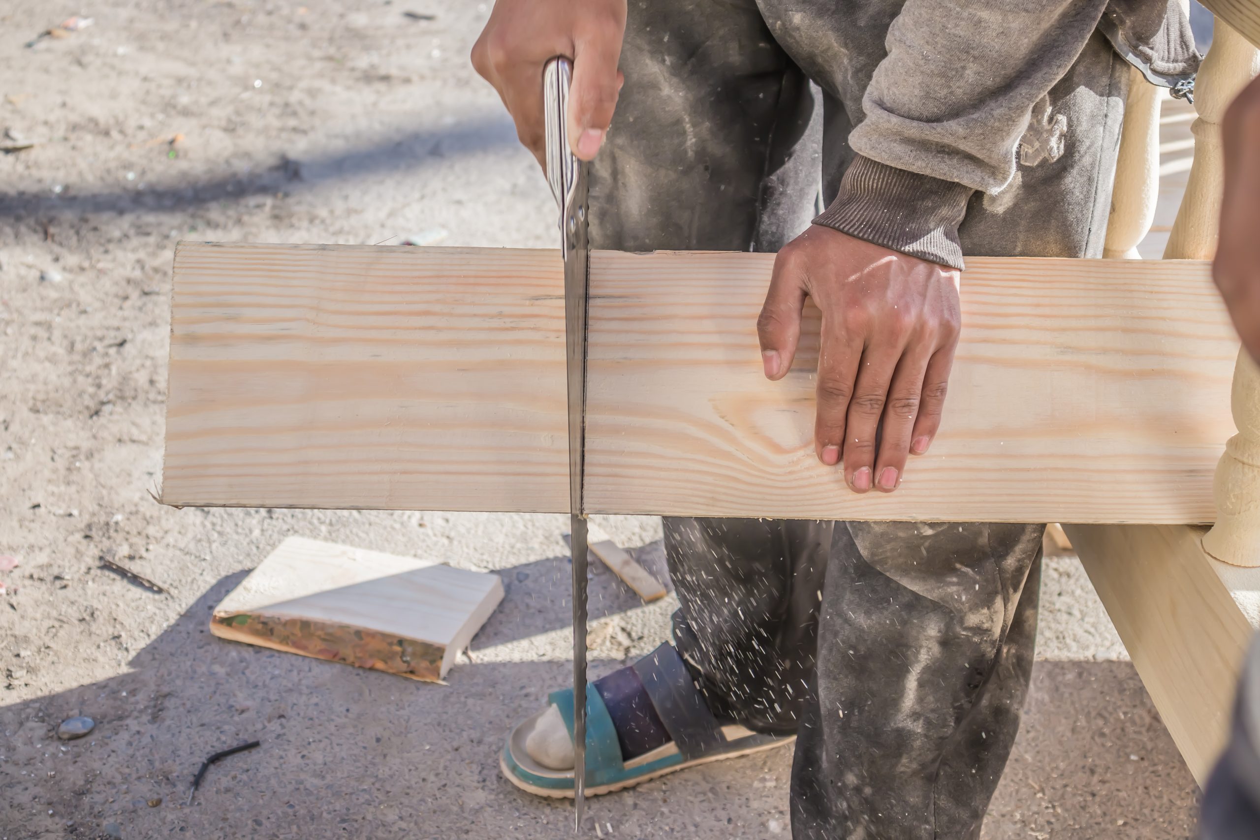 board-is-sawn-with-hand-saw-with-hacksaw-wood