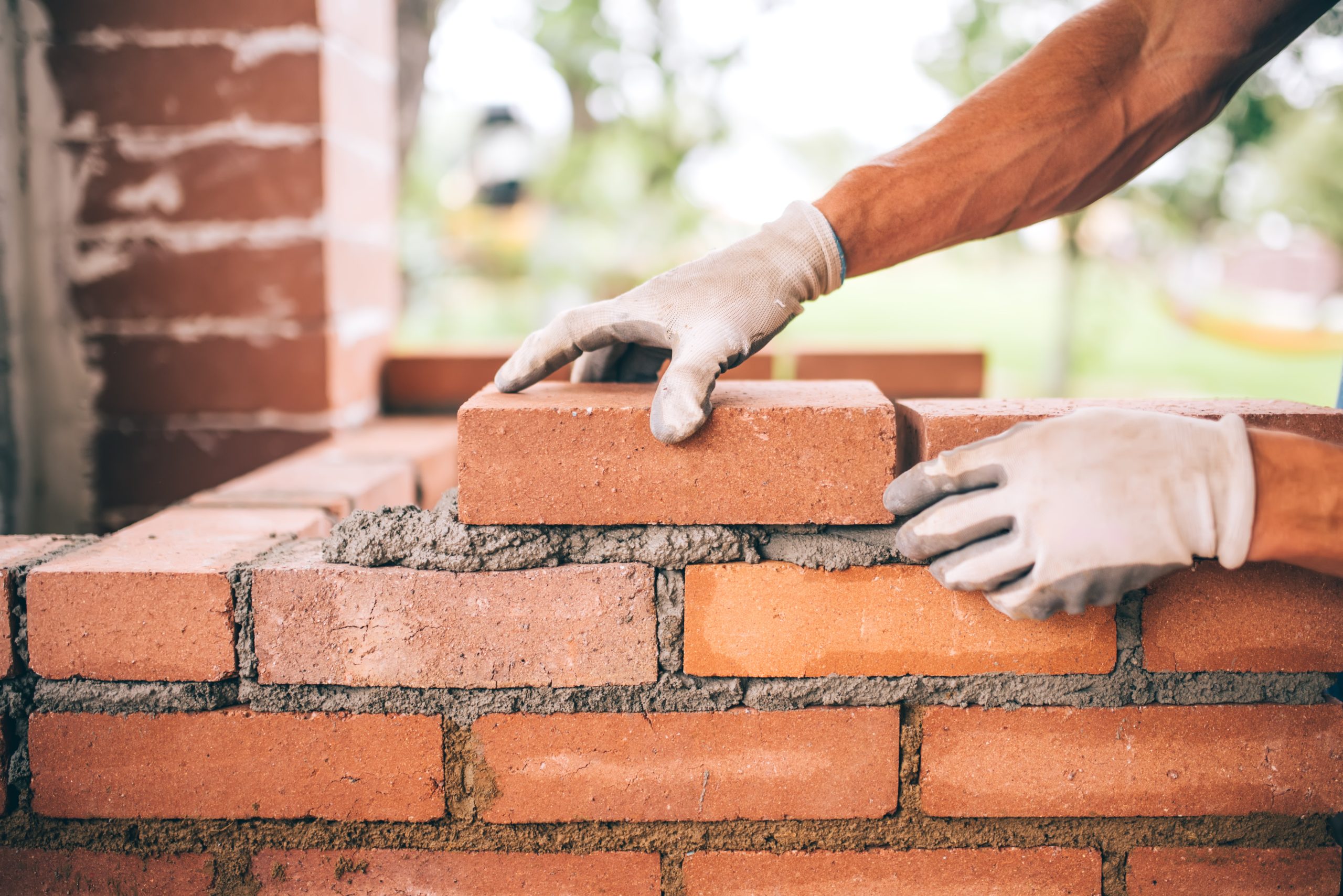 professional-construction-worker-laying-bricks-building-barbecue-industrial-site-detail