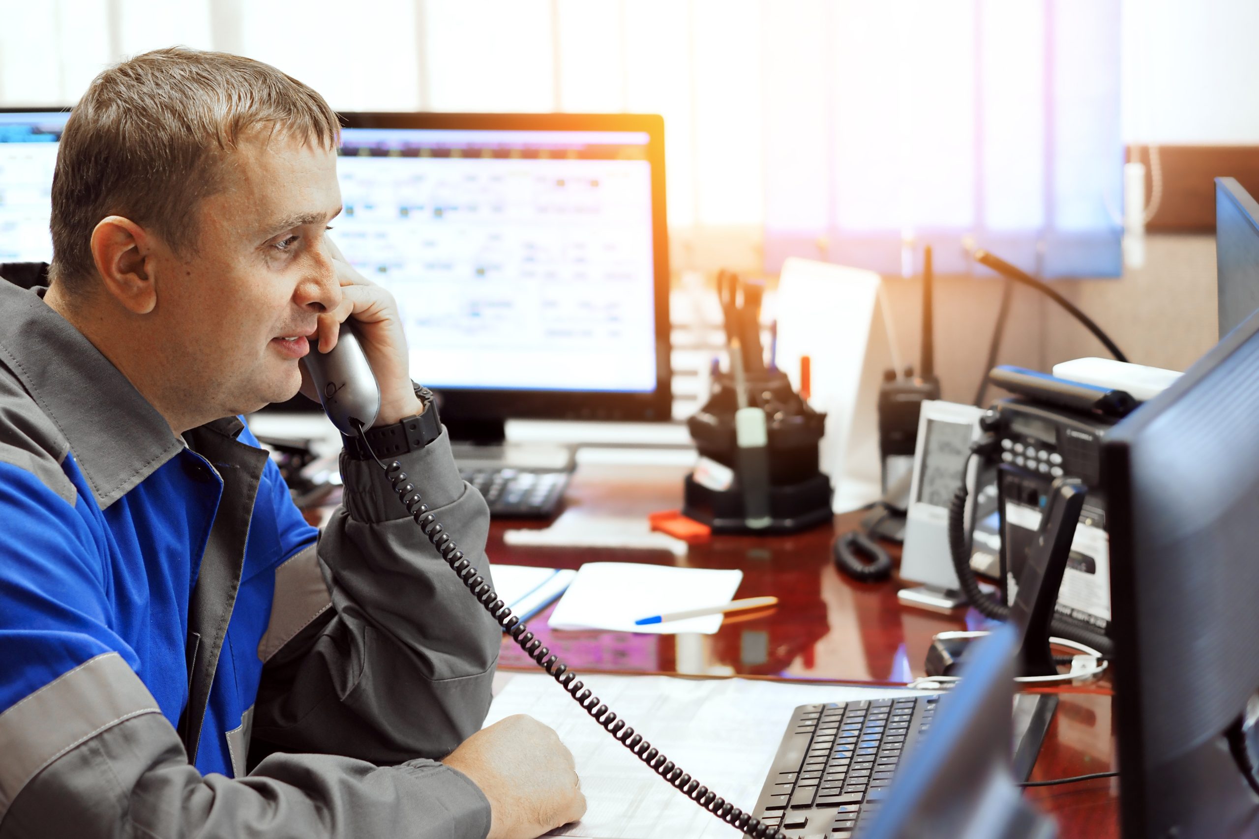 telephone-line-operator-answers-phone-looks-computer-monitor-middleaged-caucasian-dispatcher-work-authentic-workflow